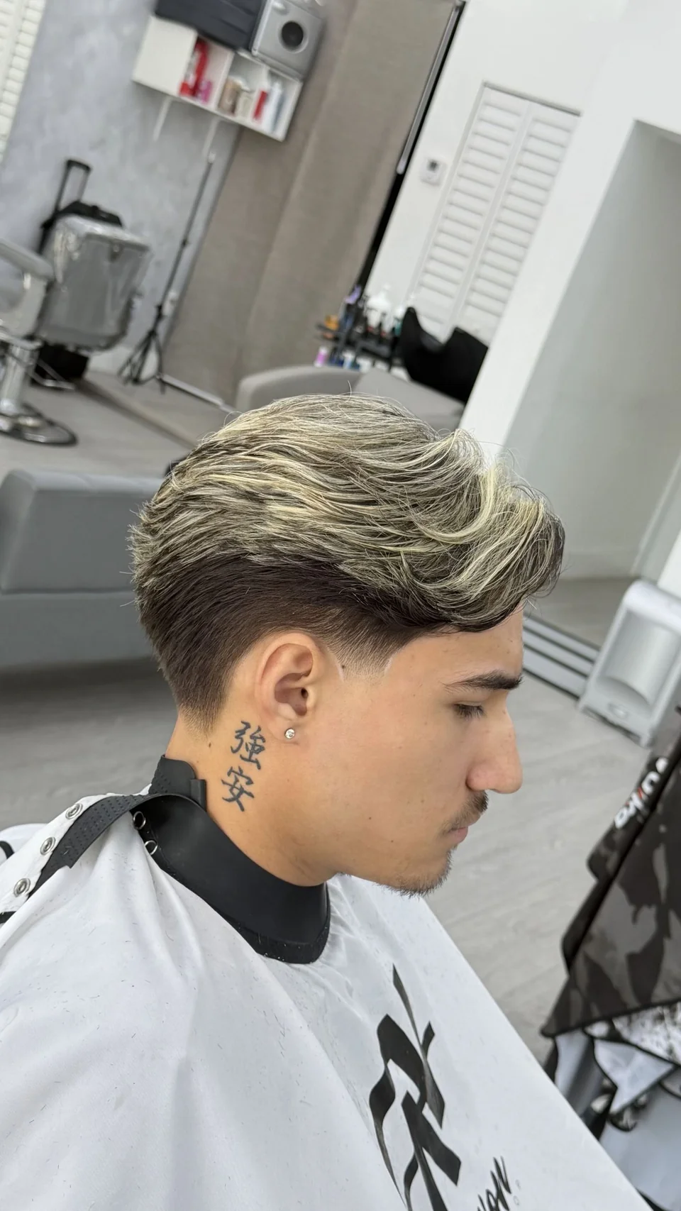 Blond highlights through a longer, styled top with tapered sides