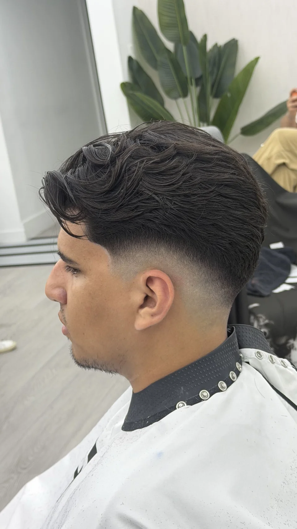 A finished skin fade with a dark, textured top