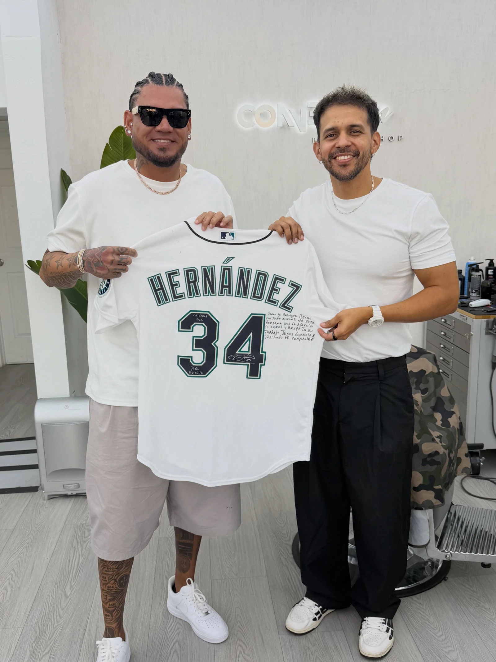 Jesus Q. with a visitor at Connection Barbershop