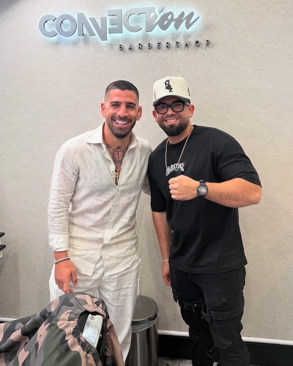 A client and barber smiling together at Connection Barbershop